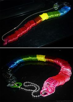 two pictures of different colored bracelets on a black surface and one has a chain attached to it