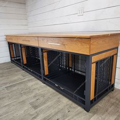 the dog kennel is made out of wood and has metal bars on each side