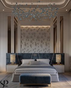 a large bed sitting under a chandelier in a bedroom