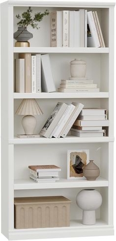 a white book shelf filled with lots of books and knick - knacks