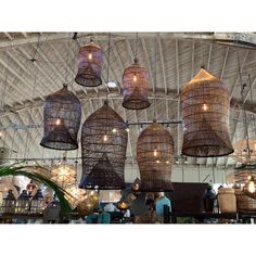 several hanging wicker baskets are suspended from the ceiling