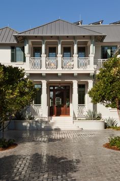 a large white house with lots of windows and balconies