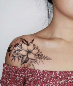 a woman with a flower tattoo on her shoulder