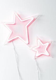 two pink neon stars on white background