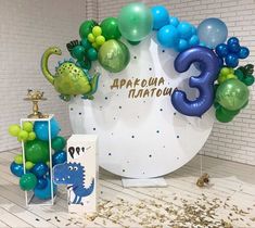 balloons and decorations are displayed in front of a backdrop