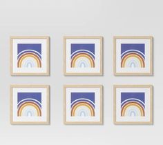 four framed art pieces with rainbows on them in different shapes and sizes against a white wall