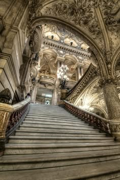 an ornate staircase leading up to the top floor