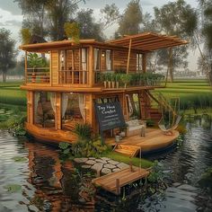 a floating house on the water surrounded by greenery