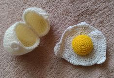 two crocheted eggs sitting on top of a rug