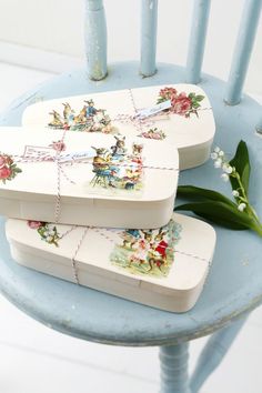 three pieces of porcelain sitting on top of a blue chair