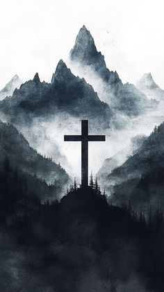 a cross on top of a mountain with fog in the air and mountains behind it