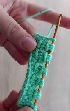 someone is crocheting the end of a piece of yarn