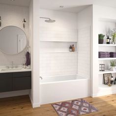 a bathroom with white walls and wooden floors, including a bathtub in the center