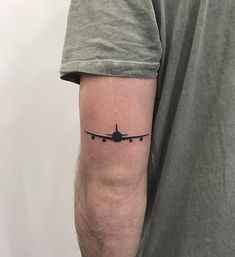 an airplane tattoo on the arm