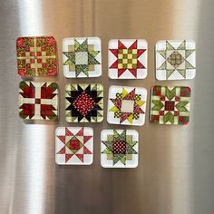 nine patchwork coasters are arranged on a stainless steel surface