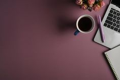 an open laptop computer sitting on top of a desk next to a cup of coffee