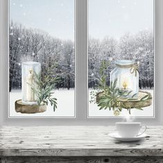 a cup and saucer sit on a table in front of two windows with frosted trees outside