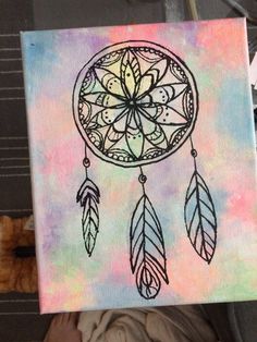 a drawing of a dream catcher on a piece of paper with watercolor paint and black ink