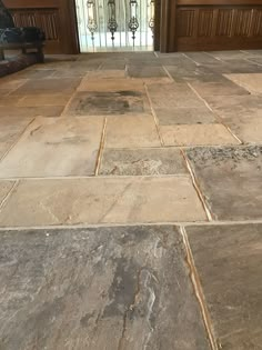 the entrance to a house with stone flooring