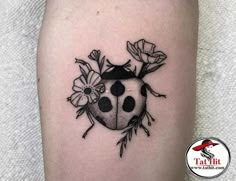 a ladybug tattoo on the right thigh