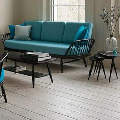 a living room filled with furniture next to a window