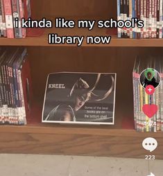 a book shelf filled with lots of books next to a sign that says i kinda like my school's library now