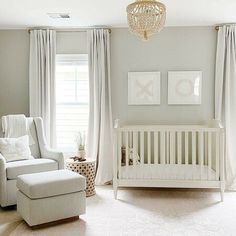 a baby's room is decorated in neutrals and whites