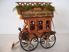 a wooden wagon with plants growing out of it's roof and windows on wheels