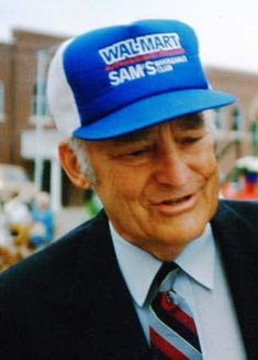 an older man wearing a hat and tie