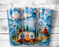 three tumbles with an image of a camper and trees on them