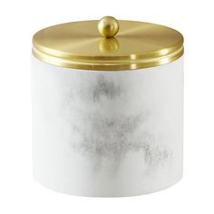 a white and gold canister sitting on top of a table