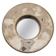 a round mirror sitting on top of a white wall