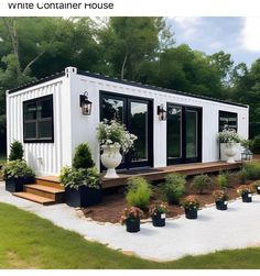 a house made out of shipping containers and plants