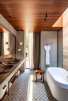 a bathroom with two sinks and a large bathtub in it's center area