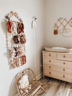 a baby's room with a crib, dresser and shoes on the wall