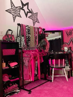 a room filled with lots of pink and black furniture next to a wall covered in stars