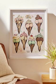 an ice cream poster hangs on the wall next to a chair and potted plant