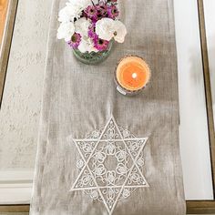 a candle and some flowers on a table