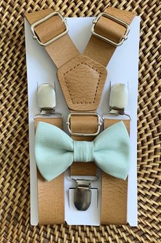 "Your special guy will look so dashing when he shows up wearing this sage green bow tie and faux leather suspenders set! This bow tie is a great choice for family photos, wedding, ring bearer outfit, page boy outfit, birthday celebration or any other special occasion. ❤ **Please Specify** SET- Bow Tie and Suspenders SUSPENDERS- One Pair of our Quality Suspenders BOW TIE - One Bow Tie on White Adjustable STRAP or Alligator CLIP **PLEASE NOTE: CLIP ON Bow Ties are Recommended/Suitable for Children Leather Suspenders Wedding, Ring Bearer Suit, Gentlemen Wear, Suspenders Wedding, Bearer Outfit, Green Bow Tie, Ring Bearer Outfit, Suspenders Set, Leather Suspenders