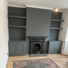 a living room with gray walls and wooden floors, an area rug on the floor