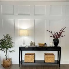 a black table with baskets and vases on it