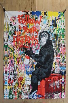 a monkey is sitting on top of a coca - cola box with graffiti all over it