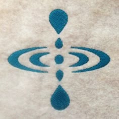 a blue and white towel with an image of a water drop on the bottom of it