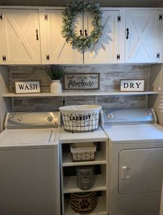 a washer and dryer sitting next to each other in a room with white cabinets