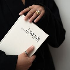 a woman holding a book in her hands with the word lisewald written on it