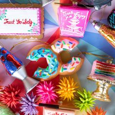 a table topped with lots of different types of cakes and desserts covered in icing