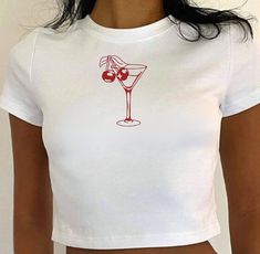 Get ready to shake things up with our Martini Baby Tee! This playful shirt features a unique martini glass design, perfect for adding a touch of fun to any outfit. So whether you're sipping on your favorite drink or just looking for a quirky statement piece, this shirt has you covered! Cheers! Colors: For color options, please refer to the listing images. Size Options: Refer to the listing images for detailed size and color options. This T-shirt usually runs true to size. Printing Method: Features DTF (Direct to Film) printing, using a heat-press mechanism for high-quality, long-lasting designs that remain vibrant over time. Care Instructions: Turn the T-shirt inside out before washing Machine wash cold with mild detergent Tumble dry on very low heat Avoid bleach and do not iron directly o Cute Party Top With Funny Print, Film Prints, Cropped Tube Top, Clothes Outfit, Martini Glass, Fall 2024, Glass Design, Baby Tee, Tube Top