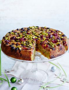 a cake that has been cut in half on a glass platter with one slice taken out