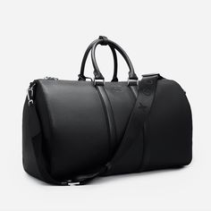 Explore elegance and utility in our Saffiano Leather Duffle Bag. Featuring intricate silver detailing and the GC logo, it makes a statement of sophistication. With two inside pockets and a removable shoulder strap, it's designed for versatility and functionality. Elevate your journey with this exquisite duffle bag. SIZE W 50 x H 29 x D 24 cm Luxury Duffel Bag, Everyday Saffiano Leather Bags With Palladium Hardware, Classic Saffiano Leather Shoulder Bag For Everyday Luxury, High-end Epsom Leather Bag For Everyday Luxury, Luxury Saffiano Leather Shoulder Bag For Everyday, Luxury Saffiano Leather Shoulder Bag, Saffiano Leather Bag For Everyday Luxury, Elegant Formal Travel Bag With Detachable Strap, Elegant Leather Duffle Bag With Detachable Strap