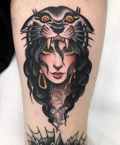 a woman with a cat's head on her thigh is depicted in this tattoo